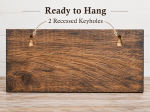 Two recessed keyholes on the back of the wooden key rack