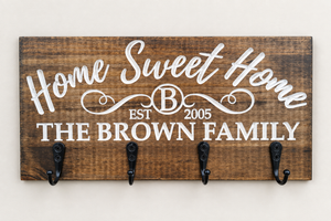 Dark pine key rack with white carved family name lettering